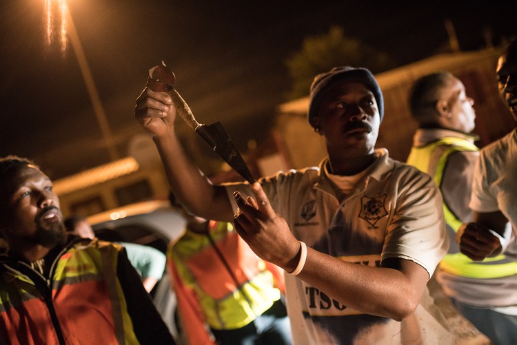 A member of Operation Wanya Tsotsi holds up a sheep shear confiscated during routine stop and searches in Galeshewe.