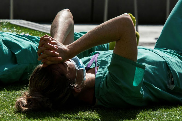 A health worker rests near the NYU Langone Hospital in the Manhattan borough of New York, US, on May 3 2020.