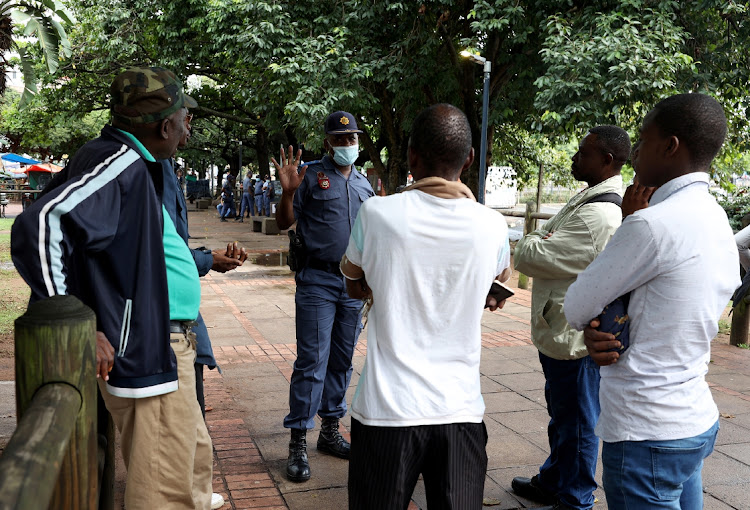 Police disperse Operation Dudula supporters outside the Workshop in Durban on April 10 2022.