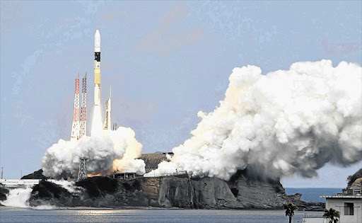 TOWARDS ETERNITY: An H-IIA rocket carrying the Hayabusa 2 space probe launches yesterday from Tanegashima Space Centre on the Japanese island of Tanegashima. The probe is on a six-year round trip to an asteroid to collect samples scientists hope will help reveal the origins of life