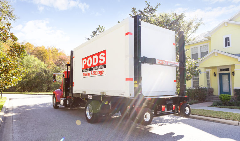 A PODS truck is transporting a PODS container out of a California neighborhood to its new home in Texas. 