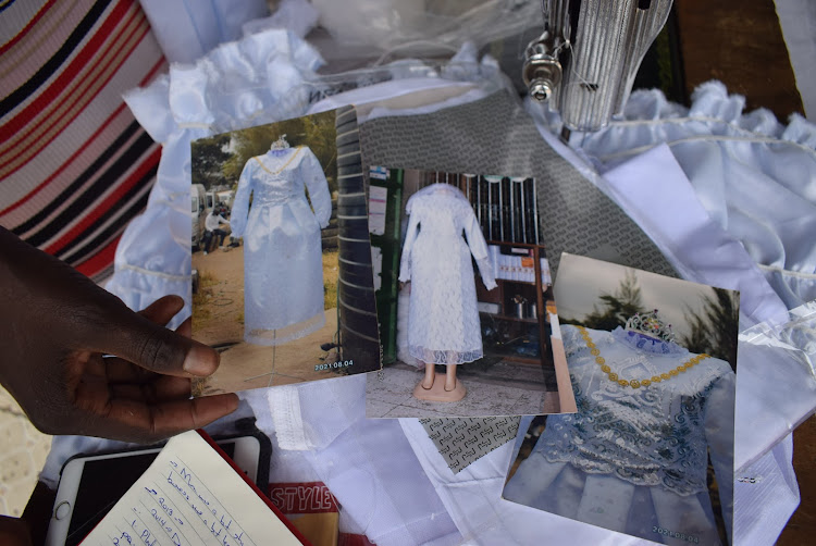 Eunice Ochieng showing samples of women's burial dresses on February 2, 2022