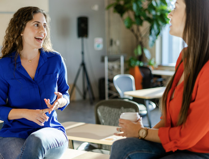 A lady is having coffee with a colleague