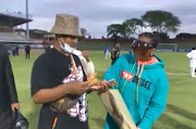 A screengrab of Shauwn Mkhize and her son Andile Mpisane handing out hard cash to  players at Royal AM after their 2-1 league win against Maritzburg United at Chatsworth Stadium.
PIC: SCREENGRAB