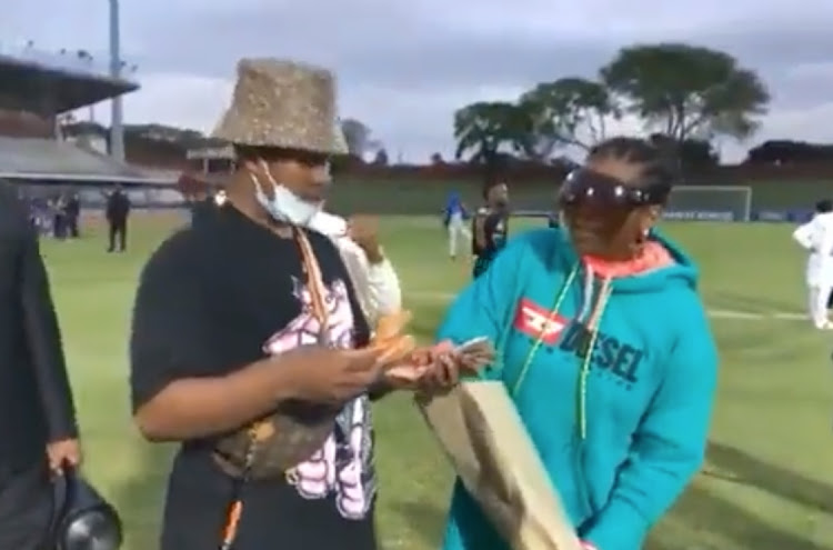 A screengrab of Shauwn Mkhize and her son Andile Mpisane handing out hard cash to players at Royal AM after their 2-1 league win against Maritzburg United at Chatsworth Stadium. PIC: SCREENGRAB