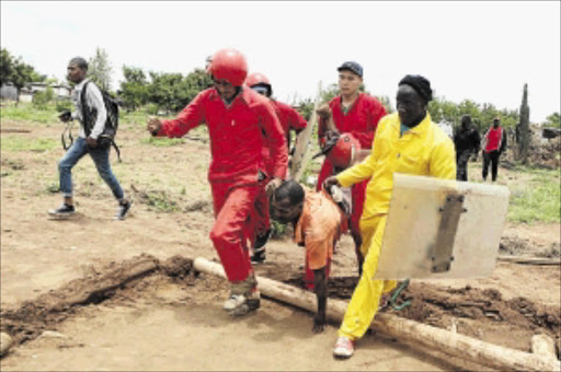 STRONG-HANDED : A land occupier in Dali Mpofu View in Soshanguve, north of Pretoria, is dragged away by security guards commonly known as Red Ants who, together with Tshwane metro officers, had demolished the shacks PHOTO: MOHAU MOFOKENG