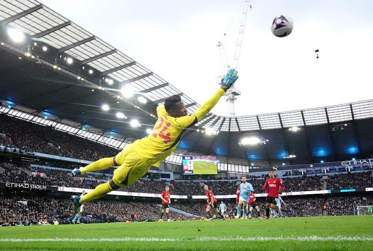 Phil Foden scores Manchester City's first goal past Manchester United's Andre Onana in their Premier League match at Etihad Stadium in Manchester on Sunday.