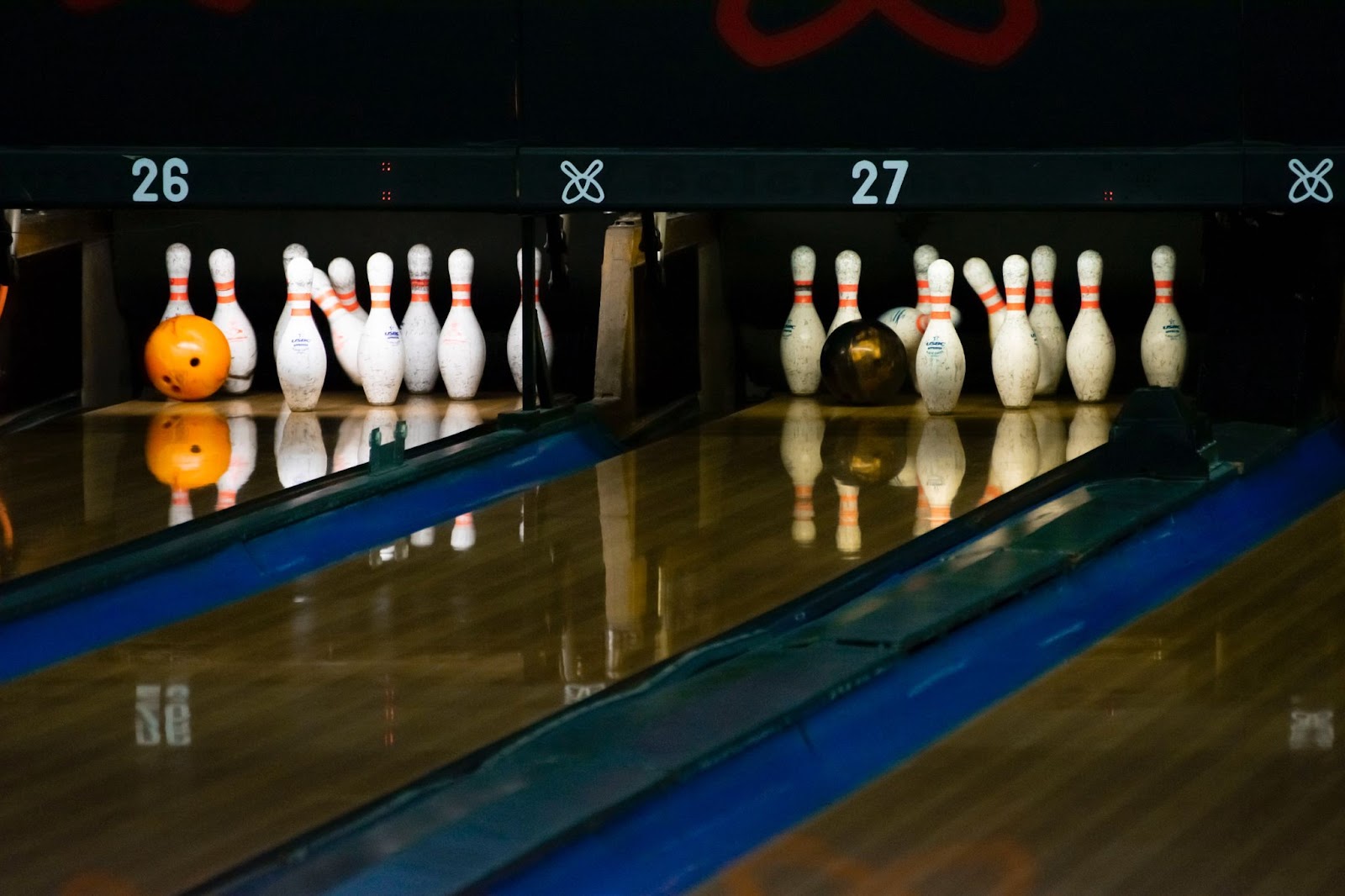 a bowling ball knocking down one pin in a lineup at one of Kelowna's bowling theatres