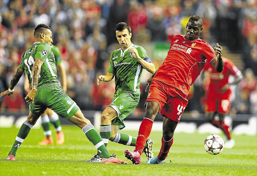 GAME-BREAKER: Mario Balotelli of Liverpool, right, battles with Anicet Abel of Ludogorets in the Uefa Champions League Group B match at Anfield last night. Balotelli scored the opening goal in his team's 2-1 victory over the Bulgarian champions