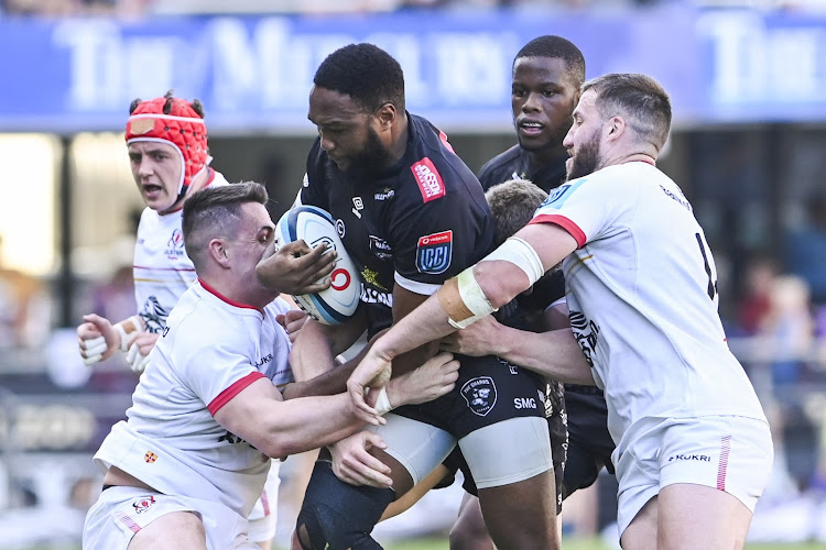 Sharks captain Lukhanyo Am challenged by Ulster players during their United Rugby Championship match at Hollywoodbets Kings Park Stadium.