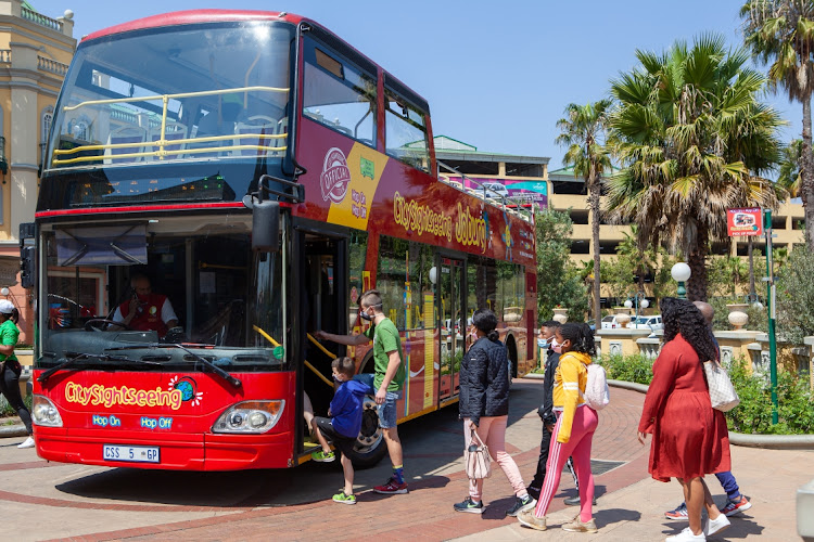 People take a tour in the open-top sightseeing bus on Heritage Day on September 24, 2020 in Johannesburg, South Africa. It is reported that the City Sightseeing bus officially returned on Heritage Day after being closed down due to the Covid-19 pandemic.