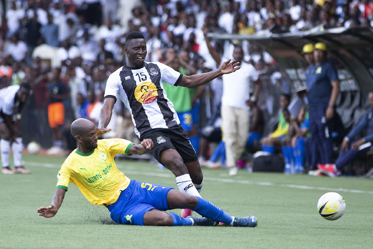 Cheick Oumar Fofana of TP Mazembe challenges Khuliso Mudau of Mamelodi Sundowns during the CAF Champions League match on Saturday