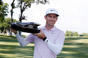 Dylan Frittelli poses with the trophy after winning the John Deere Classic golf tournament at TPC Deere Run at Silvis, Illinois in the US on July 14, 2019.