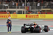 Sergio Perez looks at his car after retiring from the race during the F1 Grand Prix of Bahrain at Bahrain International Circuit on March 20 2022.