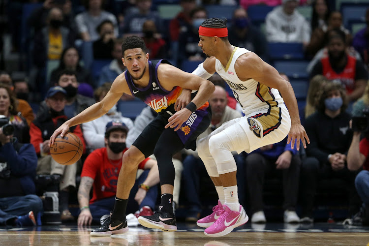 Phoenix Suns guard Devin Booker (1) is defended by New Orleans Pelicans guard Josh Hart (3) in the first quarter at the Smoothie King Center.