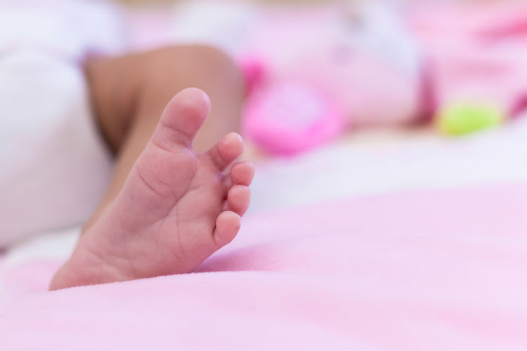 The woman, who claimed to be a social worker, convinced the mother to let her hold the infant. Stock photo.