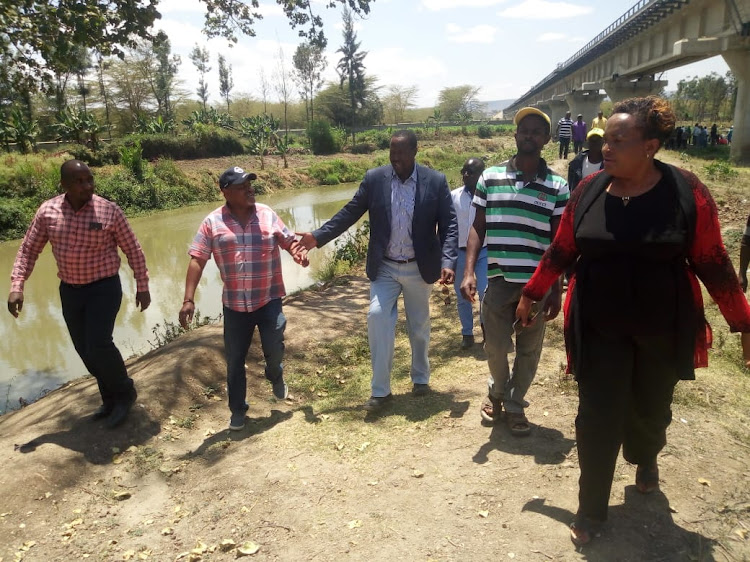 Machakos Majority leader Mark Muendo (2ND L, in baseball cap) MCAs on fact-finding tour of River Athi in Mavoko subcounty on Monday.