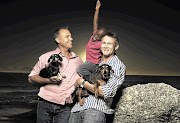 Anton Middleton and Jean Paul Krooneman at Camps Bay with their six-year-old adopted son Picture: ROB DURAND