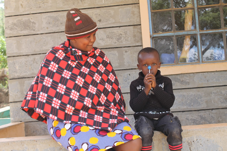 Jackline Mwende with her 4-year-old son Gift Safari outside her house at her mother's home at Kathama in Mwala, Machakos County on Wednesday, April 7.