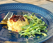 Twice-baked cheese soufflé with red onion marmalade and fresh rocket.