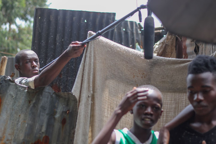 Tony Onyango holds a mic stand