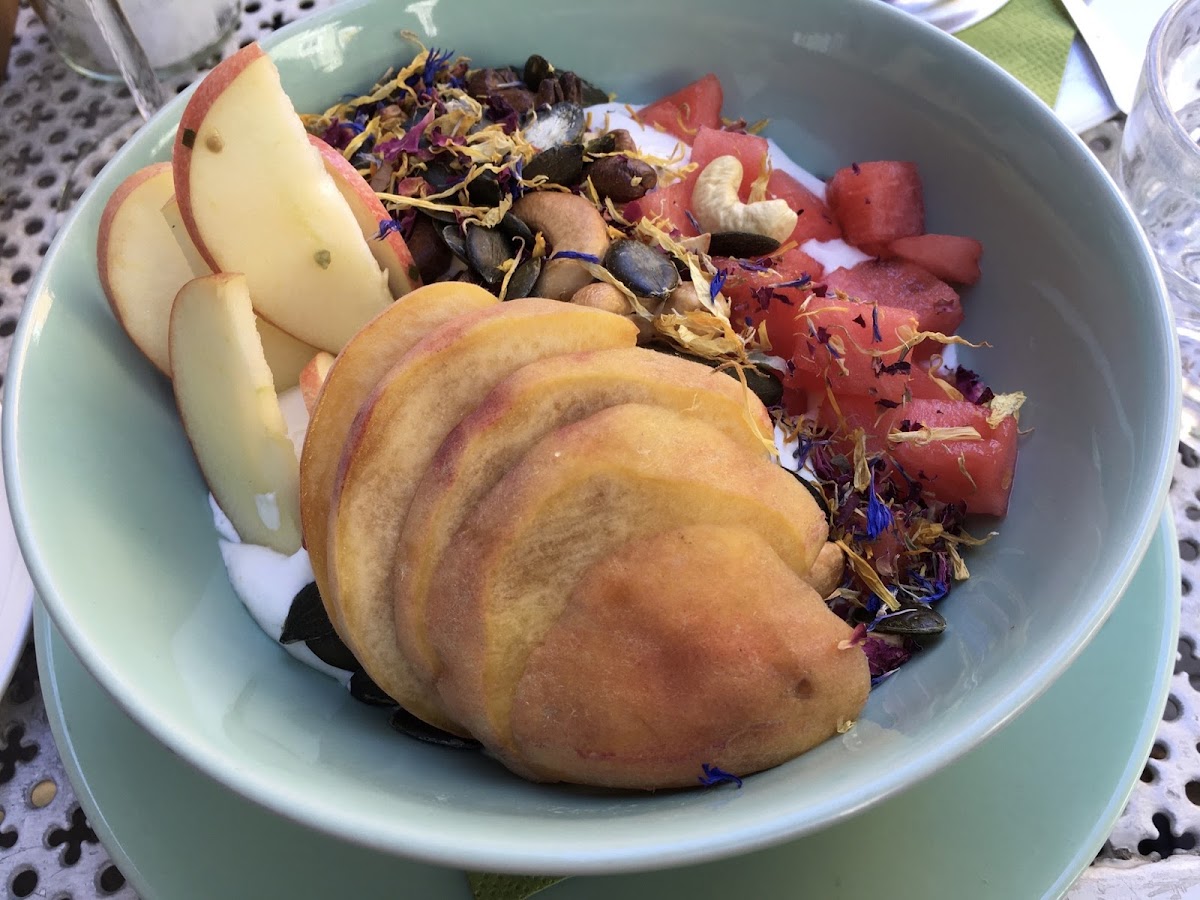 Breakfast Bowl (vegan, gluten free) with coconut cream, fresh fruit, seeds & nuts