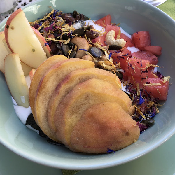 Breakfast Bowl (vegan, gluten free) with coconut cream, fresh fruit, seeds & nuts