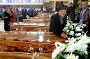 DAY OF RECKONINGZwelifumile Mjekula lays a wreath on her brother Nomvula Gitywa's coffin at a handover ceremony of the exhumed remains of executed United Democratic Front activists