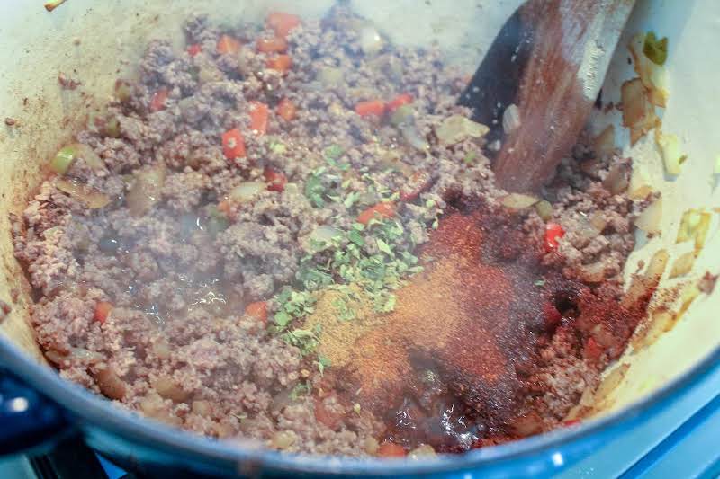 Adding Ground Beef And Mexican Oregano.