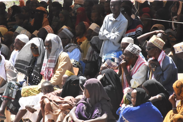 Residents seating under the scorching sun during the 60th Madaraka Day celebrations in Merti, Isiolo County on June 1, 2023