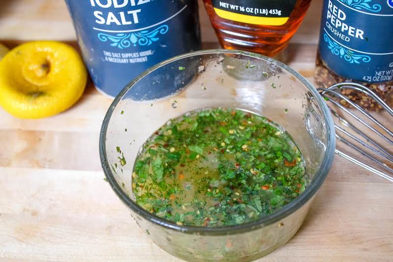 Whisking Dressing Ingredients In A Bowl.