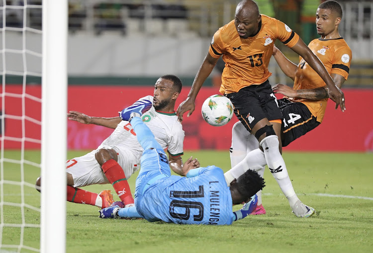 Ayoub El Kaabi of Morocco tackled by Lawrence Mulenga and Stoppila Sunzu of Zambia during their Africa Cup of Nations (Afcon) match at Laurent Pokou Stadium.