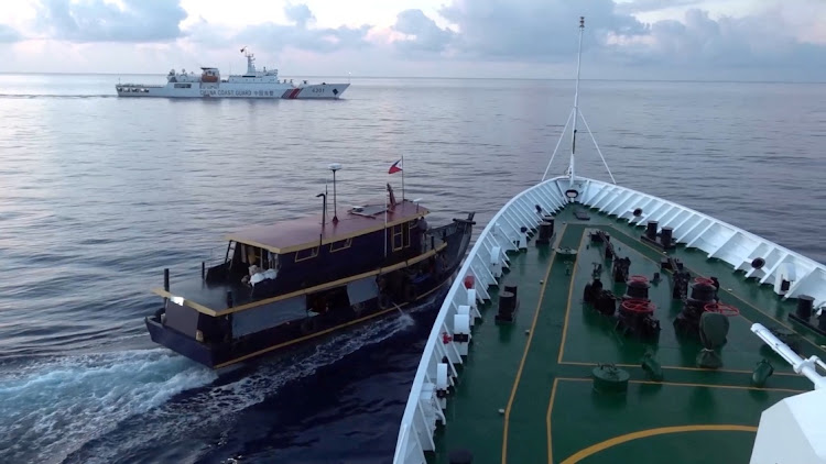 A Philippine flagged boat is blocked by a China Coast Guard vessel during an incident that resulted in a collision between the two vessels, in the disputed waters of the South China Sea in this screen grab obtained from handout video released on October 22 2023. Picture: China Coast Guard via REUTERS