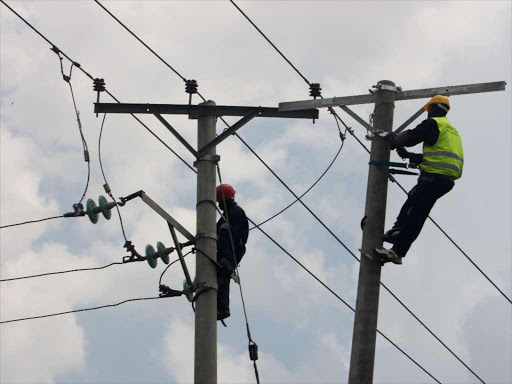 Kenya Power technicians repairs electricity line along the Likoni road in Nairobi on February 7. Disruptions lasting more than three hours will see affected customers compensated in proposed law by Parliament. The Energy Bill, 2015 is at the third reading stage Photo/FILE.