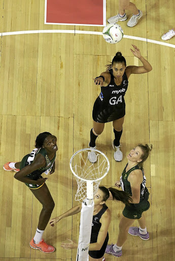 Proteas Phumza Maweni, left, and Karla Pretorius, right, watch Sliver Ferns goal attack Maria Tutaia shoot for a goal. /Supplied