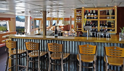 The lounge/bar on Wilderness Adventurer has several beers on tap, with bar and bench seating.