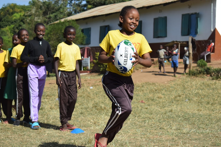 Girls engaging in rugby passing drills