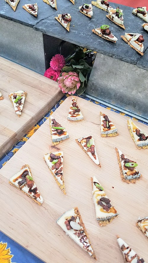 At the California Artisan Cheese Festival Best Bite Competition, Michele Wynne and Paige Icardi from Bi-Rite Market, San Francisco used Pluvius from Willapa Hills Cheese with a homemade super seed cracker, rind dust, ginger infused balsamic reduction, candied bacon, and scallions