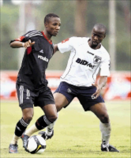 MERCURIAL: Bucs' Teko Modise dribbles past BidVest Wits' Richard Gariseb in thier Absa Premiership game at BidVest Stadium on Saturday. Pirates won 2-0. 24/01/2009. Pic. Chris Ricco. © Backpagepix.