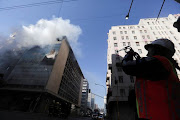 Firefighters on the scene at the  Gauteng Premier's office in Johannesburg on 30 June after a fire broke out in the morning.