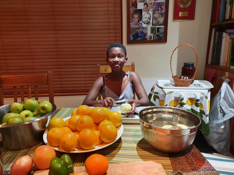 Vivian Mongile's daughter Ahlumile, 13, is under her mother's tutelage. She takes part in gathering fresh vegetables and fruit for jam and to feed hungry people.