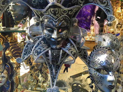 A jester's mask in a shop window along the Procuratie Vecchie on Piazza San Marco, Venice. 