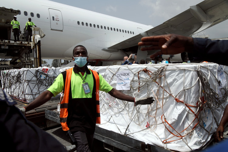 Workers offload boxes of AstraZeneca/Oxford vaccines as the country receives its first batch of coronavirus disease (COVID-19) vaccines under COVAX scheme, in Abidjan, Ivory Coast February 26, 2021.