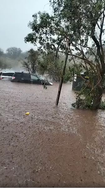 Cars and and a water tank partially submerged in Rain water in Habaswein town on sunday.