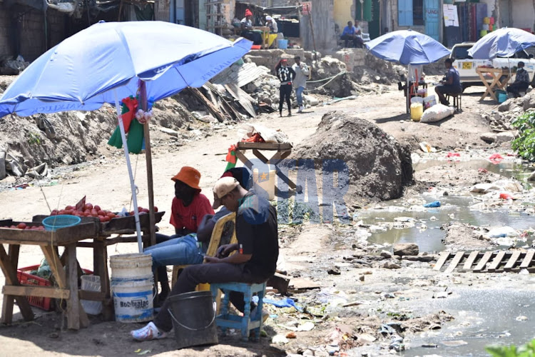 Food vendors set up their business premises across filthy waters brought about by poor drainage systems due to demolished road sections across Mukuyu Kayaba. January 26, 2022/ CHARLENE MALWA