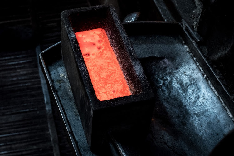 A gold bar is cooled after being smelted from recycled gold jewelry. Picture: GETTY IMAGES/CHRIS MCGRATH.