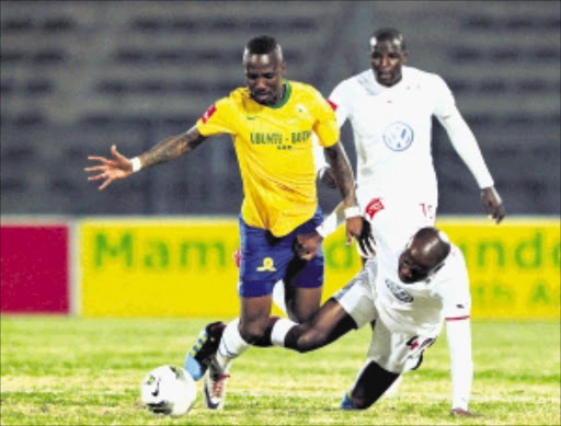 NO WAY OUT: Teko Modise of Mamelodi Sundowns, left, is tackled by MacBeth Sibaya of Moroka Swallows at Lucas Moripe Stadium last night. Photo: BackpagePix