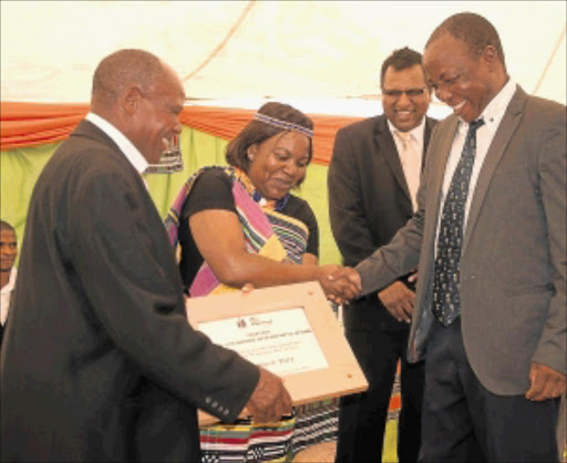 PARTNERSHIPS: Former Makhado councillor - who now heads a community project - Mshavhela Muvhumbe, right, receives a plaque on behalf of his project from traditional leader David 'Japan' Mphephu at Rabali yesterday. The others are Safcol senior executive Parmers Chetty and Makhado mayor Mavhungu Lerule. PHOTO: Benson Ntlemo