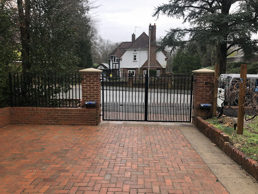 Gates installed and automated on oversized pillars, gates and railing all designated and installed to match