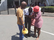 The family of the kidnapped Queens High School pupil help him as he leaves the Maponya Mall in Soweto, where he was found two days after he went missing. 